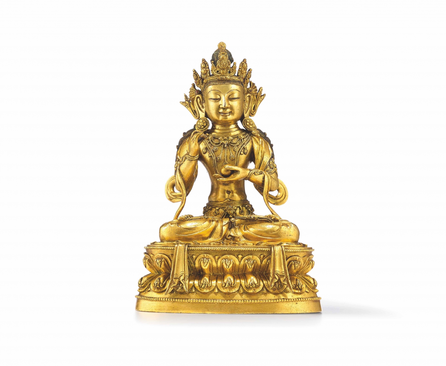 A gilt copper alloy seated figure of Avalokitesvara/Guanyin