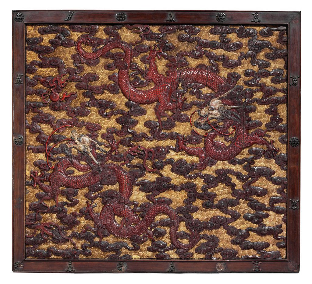 A pair of imperial carved wood, polychrome and gilt-lacquered 'dragon' panels (one of two)
