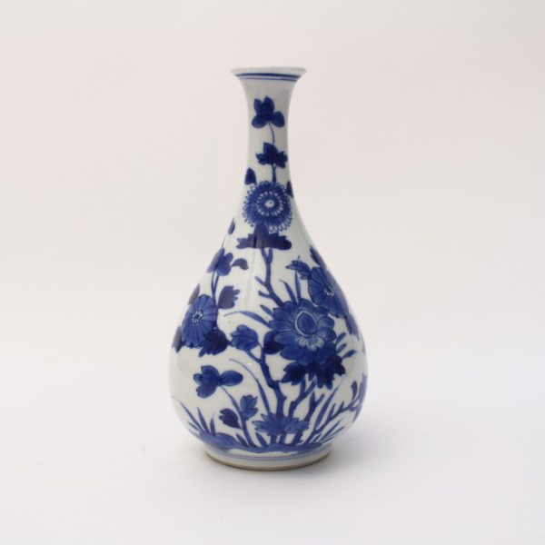 A small blue and white bottle vase
