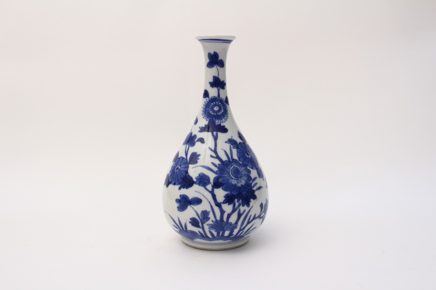 A small blue and white bottle vase