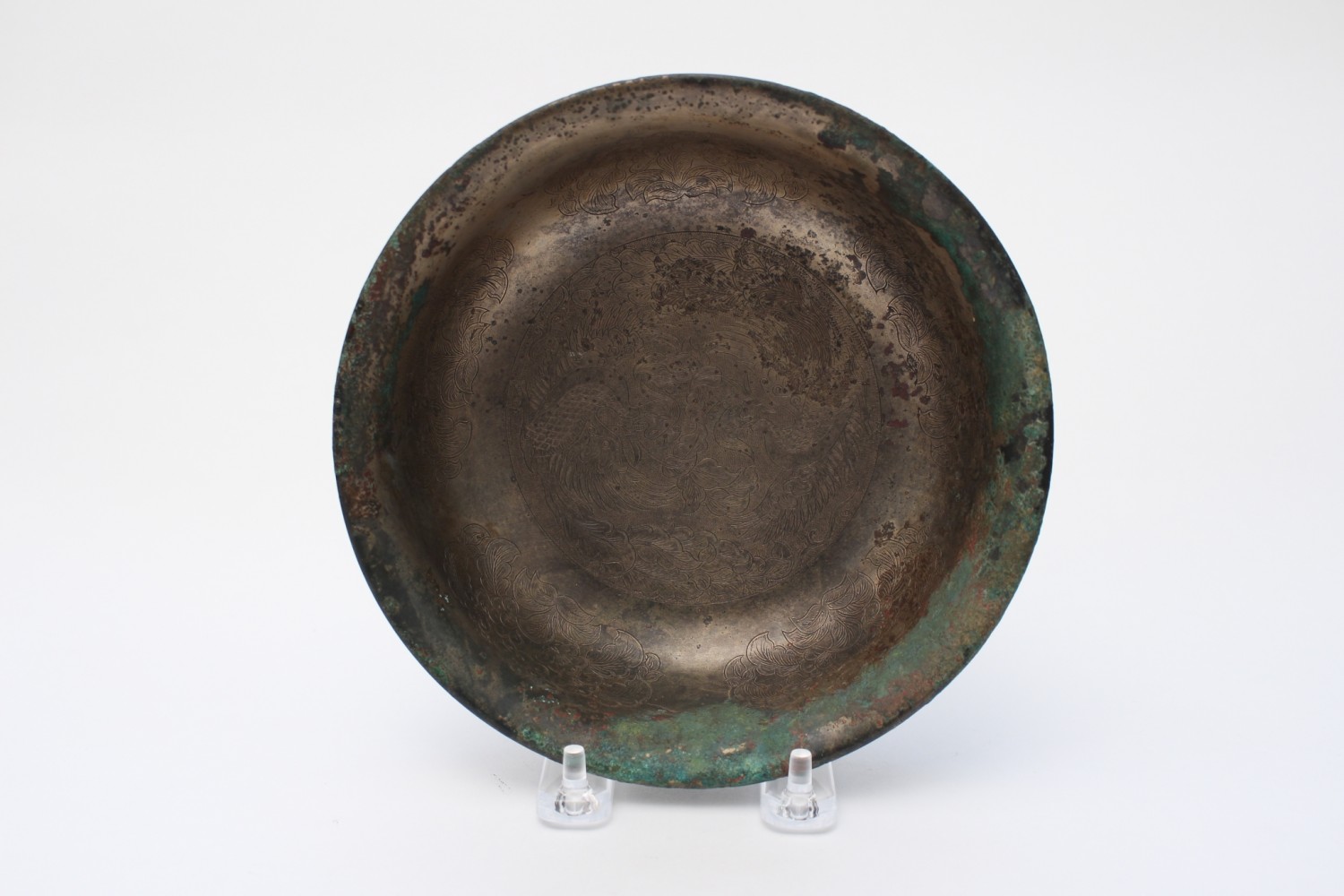 A bronze bowl with incised decoration, the outside in black lacquer
