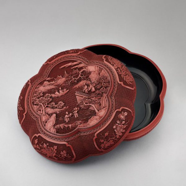 A carved cinnabar lacquer pentafoil box and cover with hardwood stand (Qianlong period, 1736-1795)